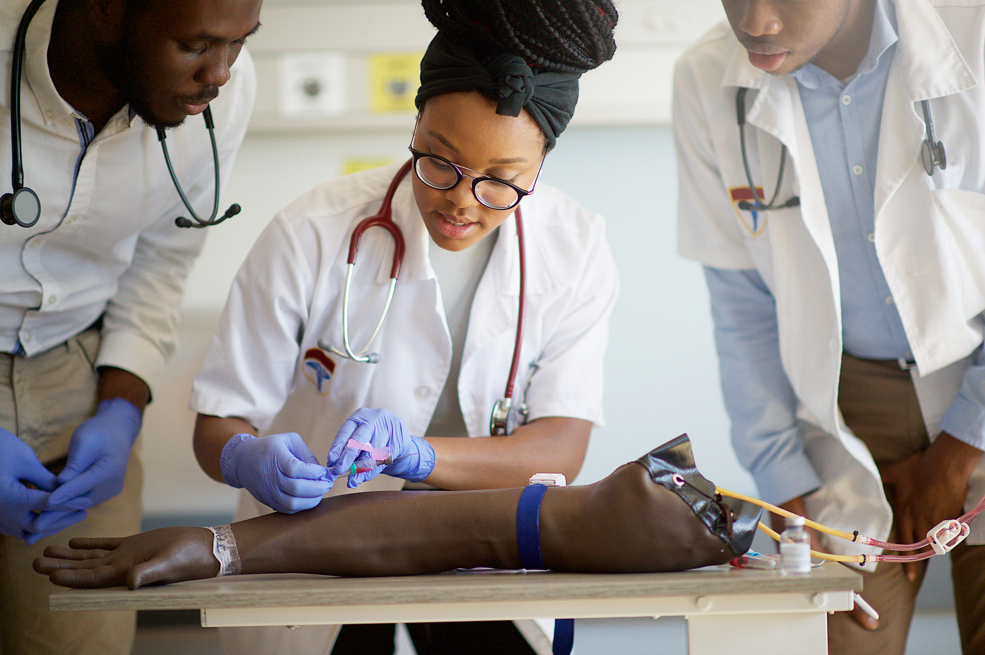 Students practising IV injection on a Phlebotomy Venipuncture Practise Arm concentration