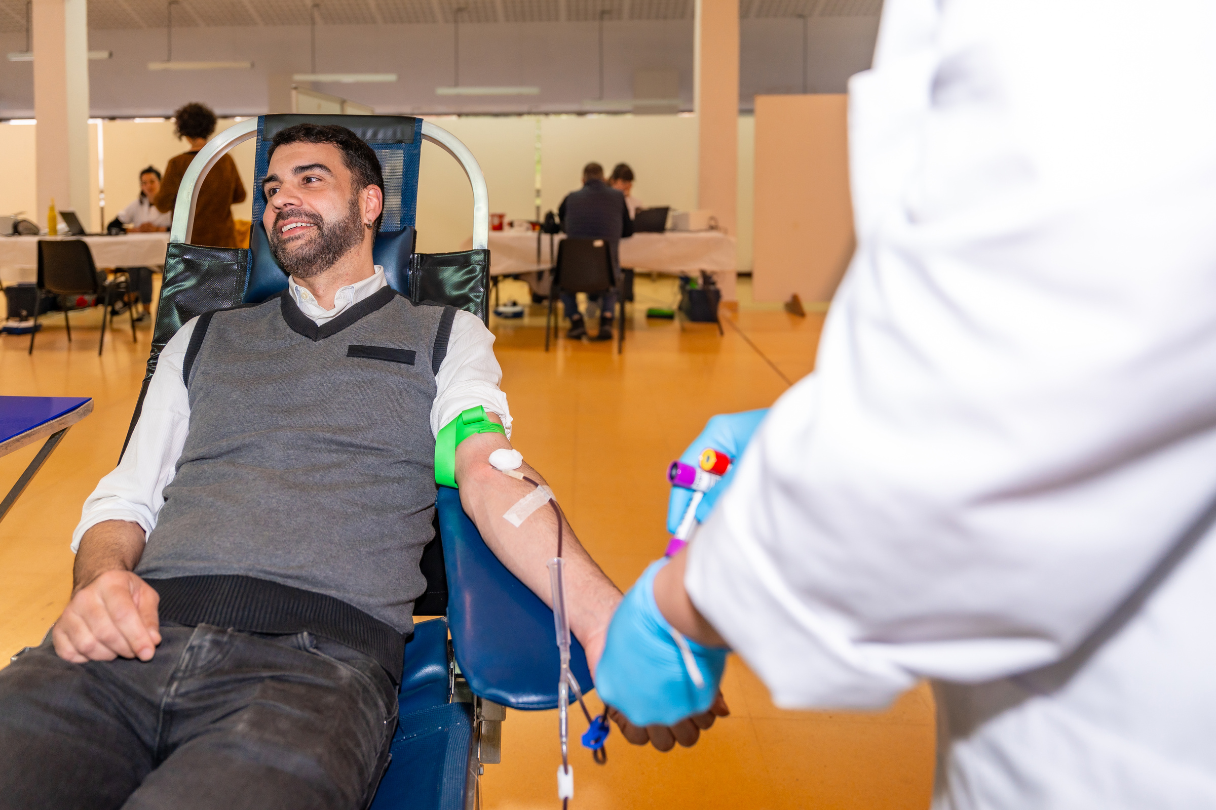 Man sitting on a comfortable chair while donating blood indoors